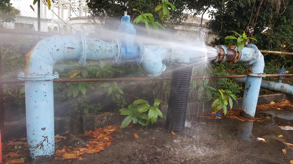 Rusty burst pipe spraying water due to failure of joint restraint; Shutterstock ID 1034383885; Purchase Order: 9184412; Job: ; Client/Licensee: ; Other:
